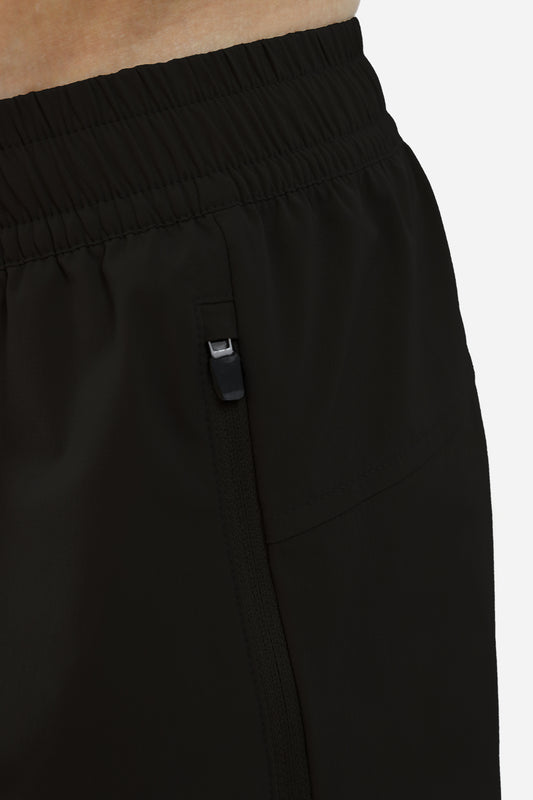 Close-up of black men's shorts with zipper pockets on a white background