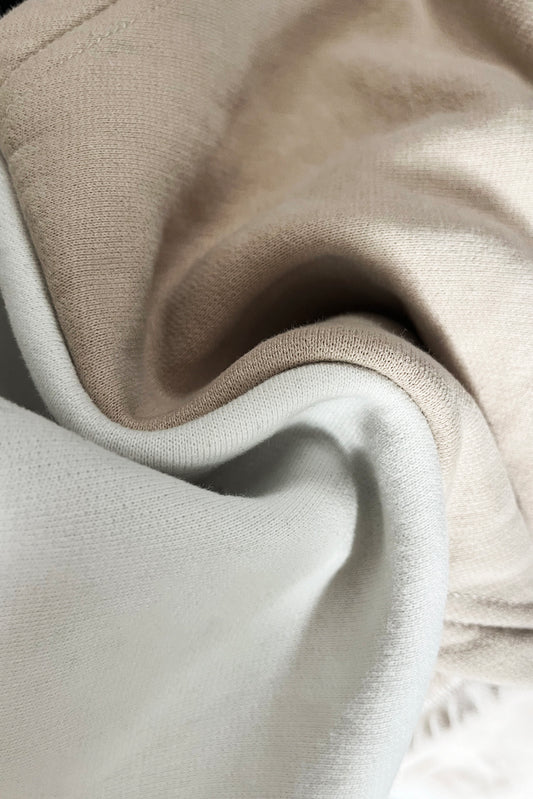 Close-up of beige and white cotton jersey fabric texture