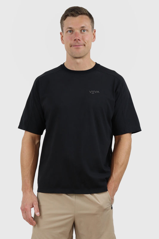 Man wearing a black cotton t-shirt with a print 'VIIVA' on the front against a white background