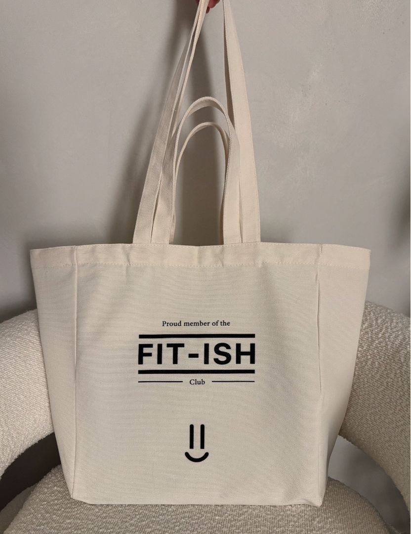 Canvas tote bag with double handle and 'Proud member of the FIT-ISH Club' text on a neutral background